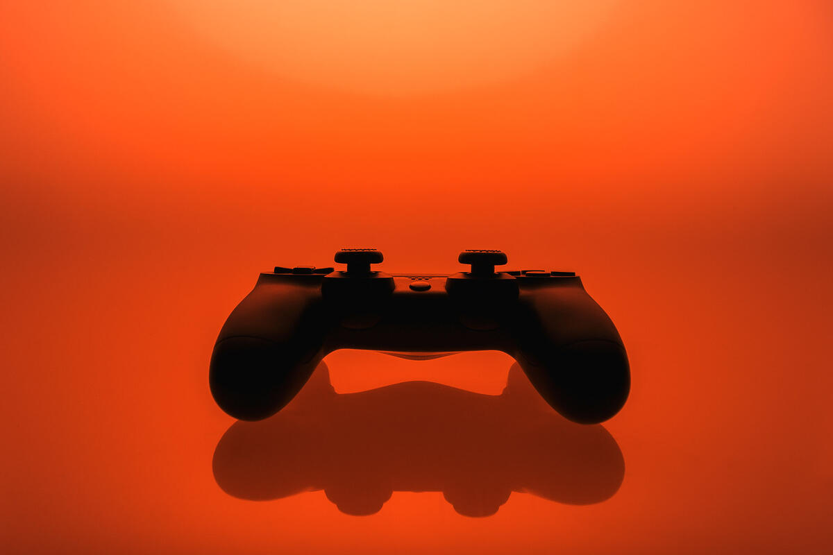 a game controller on an orange background