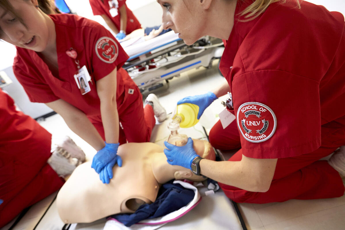 Student nurse simulating steps for CPR