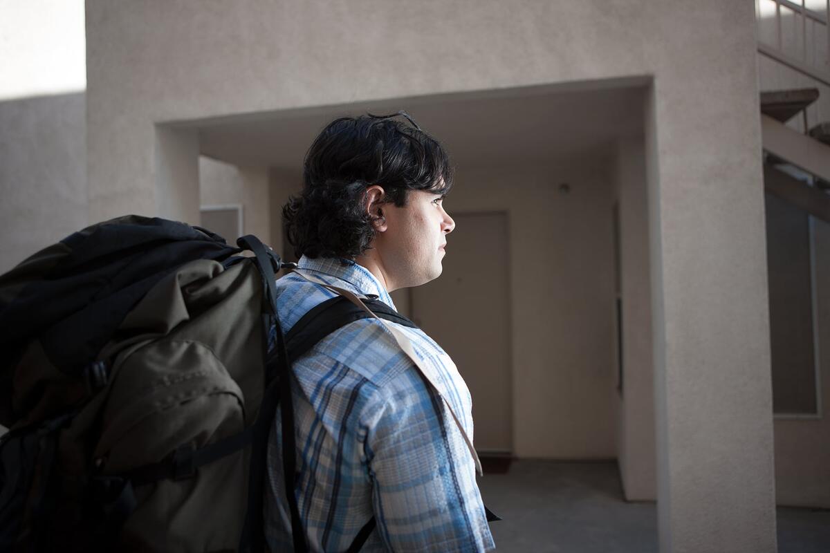 A student wearing a backcountry backpack facing the right.