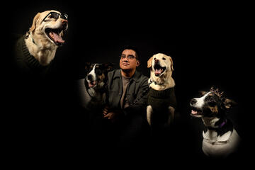 A portait of Hugo Silva with his two dogs, Juno and Hudson.