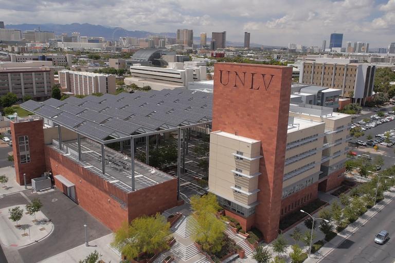 An aerial view of Greenspun Hall and UNLV campus in the background.
