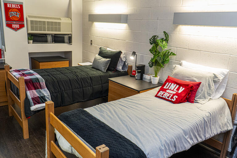Two beds side by side in a dorm room